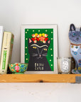Artwork of a cat with flowers, books, a candle, and a cat figurine on a shelf.