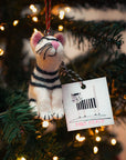 Felt tiger ornament with a tag on a decorated Christmas tree