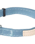 Blue cat collar with black metal clasp and bell on a white background