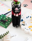 A collection of handcrafted felt cat decorations in various colors and patterns, each representing different artistic styles and characters.