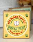 Box from The Plant Gift Co. for growing catnip plants with a cat illustration on a blurred background.
