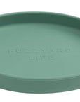 Green round cat tray with 'Fuzzyard Life' branding on a white background