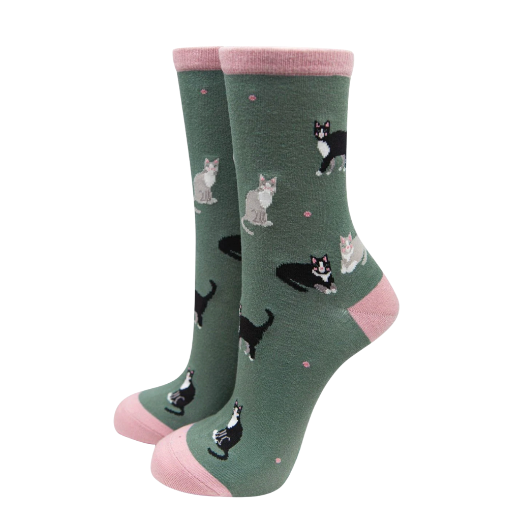 Green socks with cat pattern and pink accents on a white background
