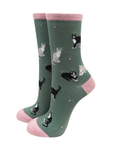 Green socks with cat pattern and pink accents on a white background