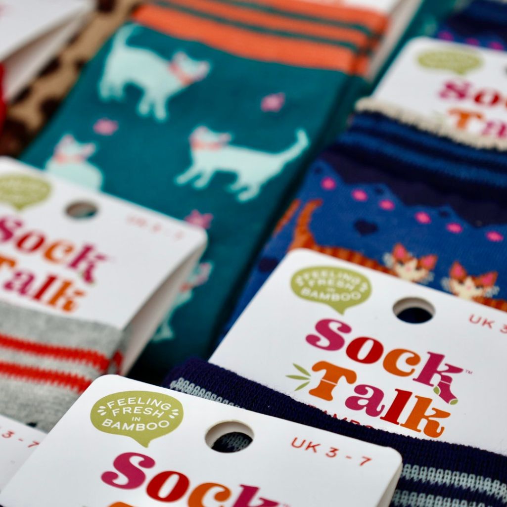 Colorful socks with &#39;Sock Talk&#39; labels and bamboo certification logos.