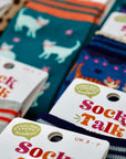 Colorful socks with 'Sock Talk' labels and bamboo certification logos.