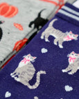 Pair of socks with cat and heart pattern on a blue background