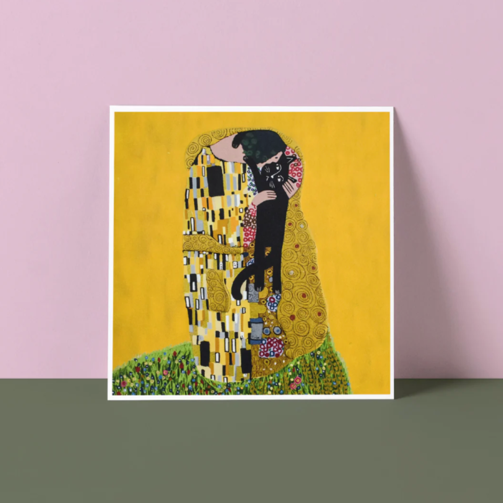 Framed artwork of &#39;The Kiss&#39; by Gustav Klimt against a pink and green gradient background