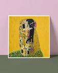Framed artwork of 'The Kiss' by Gustav Klimt against a pink and green gradient background