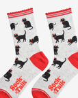 Pair of socks with festive black cat pattern and red accents on a white background