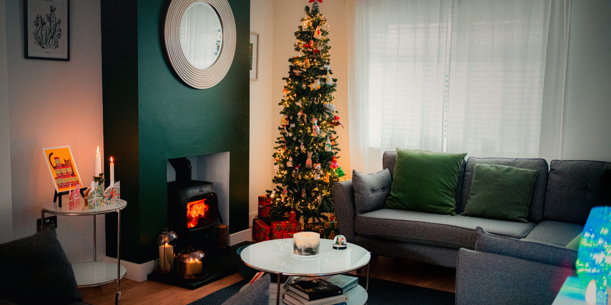 living room scene with a fireplaceand candles and a christmas tree