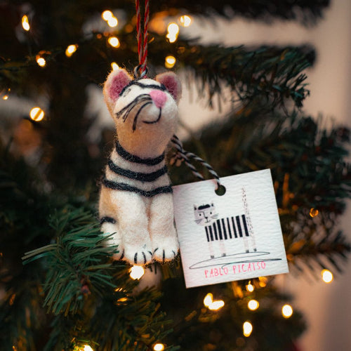 Felt tiger ornament with a tag on a decorated Christmas tree