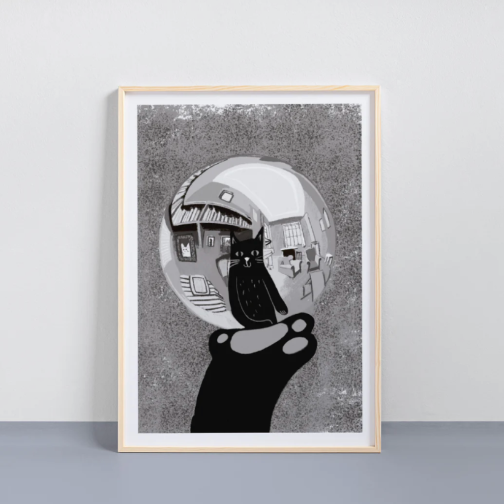 Framed artwork of a black and white abstract design on a gray background