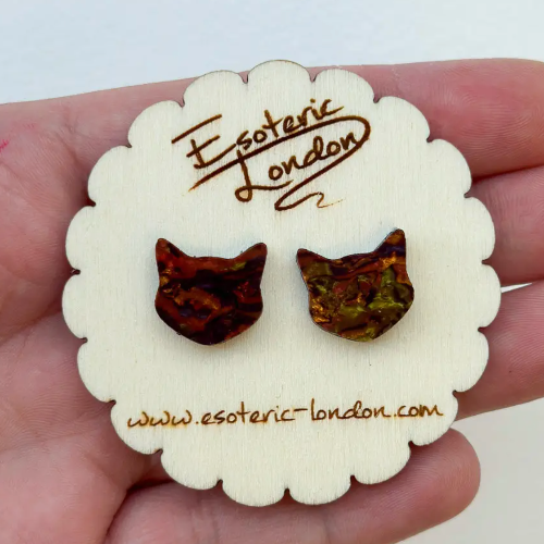 Cat-shaped earrings on a white card with 'Esoteric London' branding held in hand.