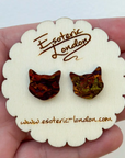 Cat-shaped earrings on a white card with 'Esoteric London' branding held in hand.