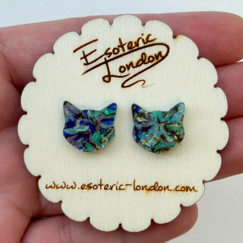 Cat-shaped earrings on a 'Esoteric London' branded card held in hand