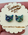 Cat-shaped earrings on a 'Esoteric London' branded card held in hand
