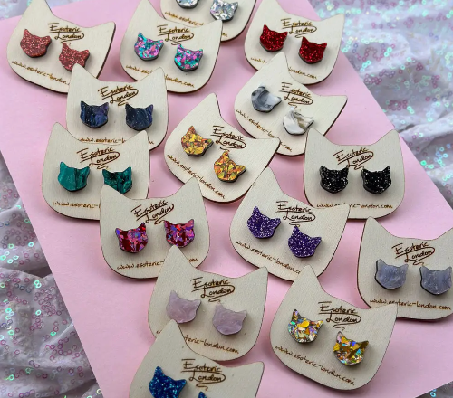 Cat-shaped earrings on display cards with &#39;Exquisite London&#39; branding.
