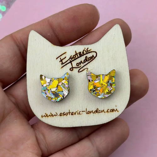 Cat-shaped earrings on a wooden display card with &#39;Esoteric London&#39; branding.