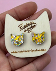 Cat-shaped earrings on a wooden display card with 'Esoteric London' branding.