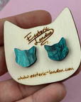 Blue cat-shaped earrings on a wooden display card with 'Esoteric London' branding.